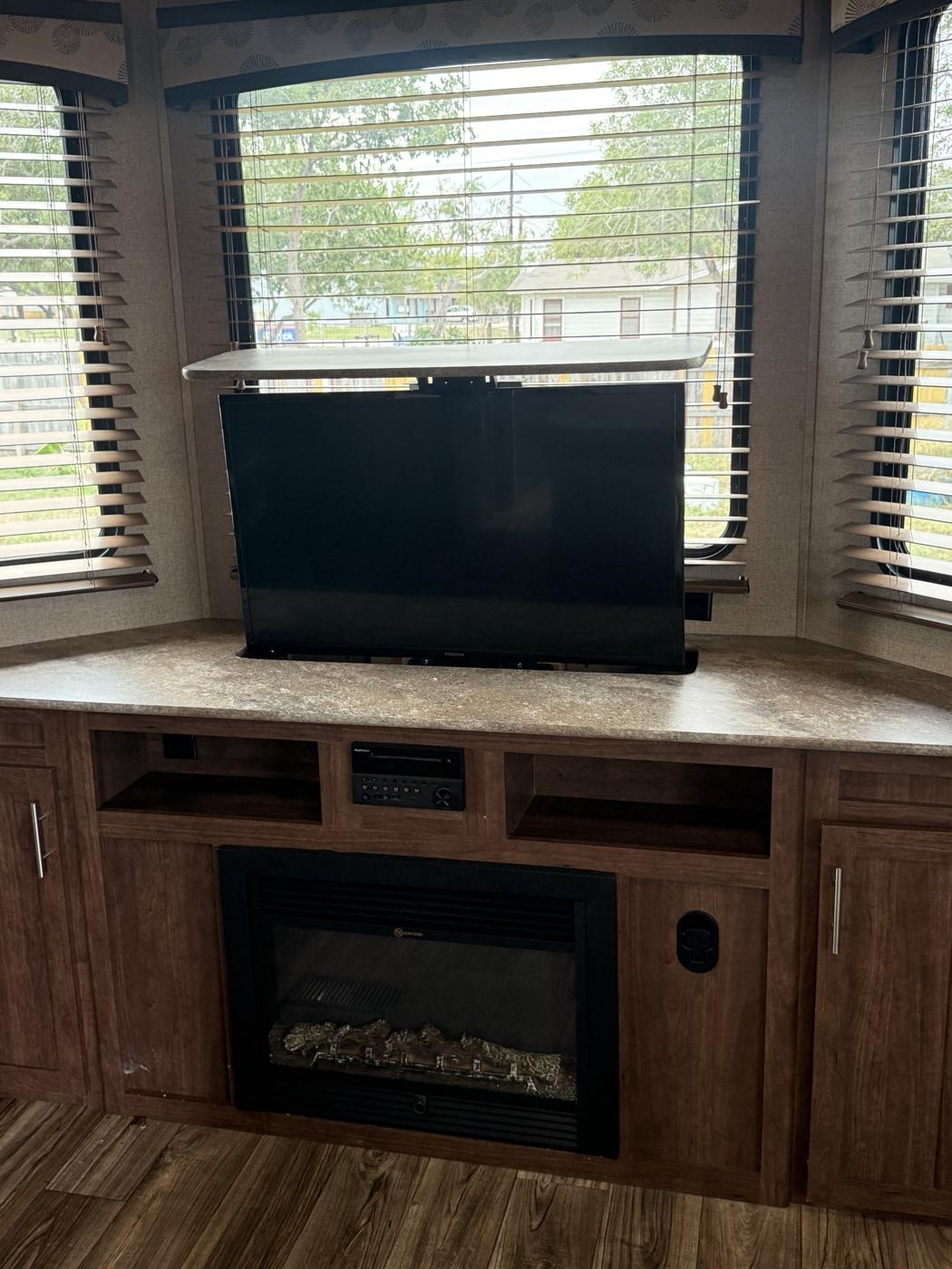 Living room bay windows with TV lift and fireplace